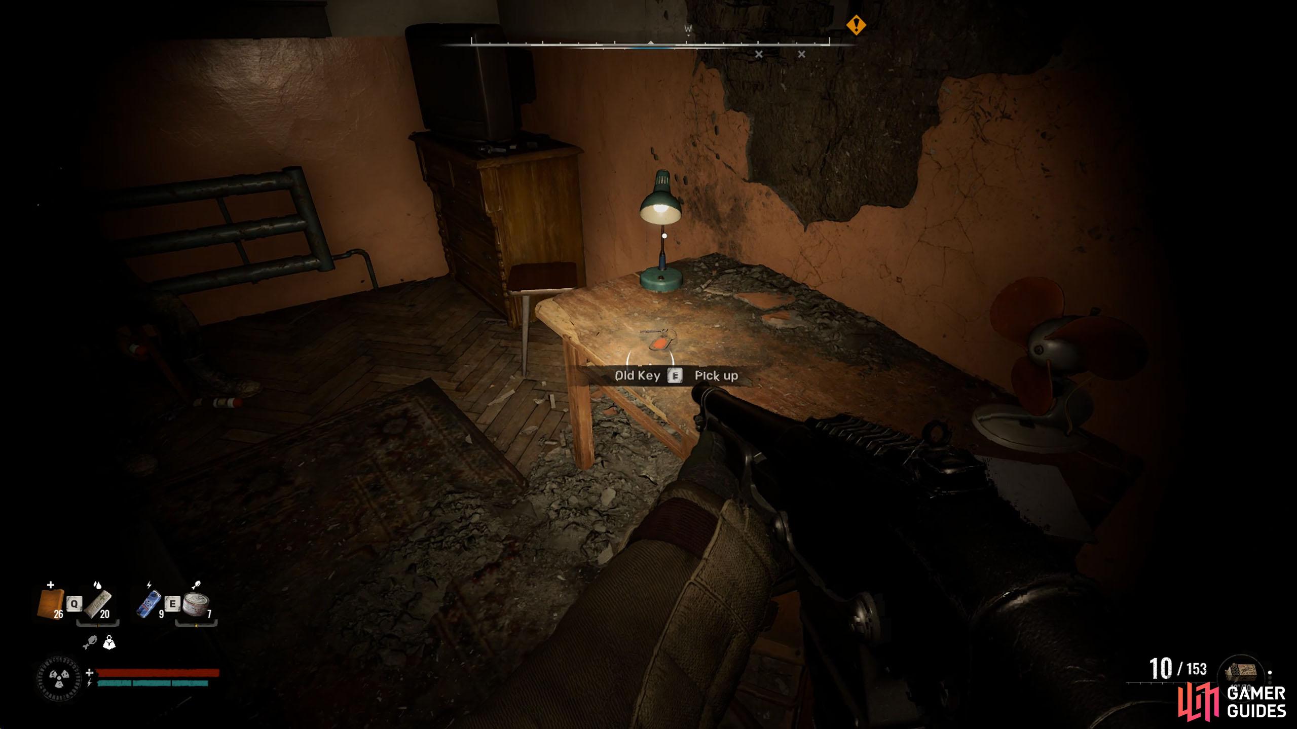 Inside the stash room, loot the old key from the desk.