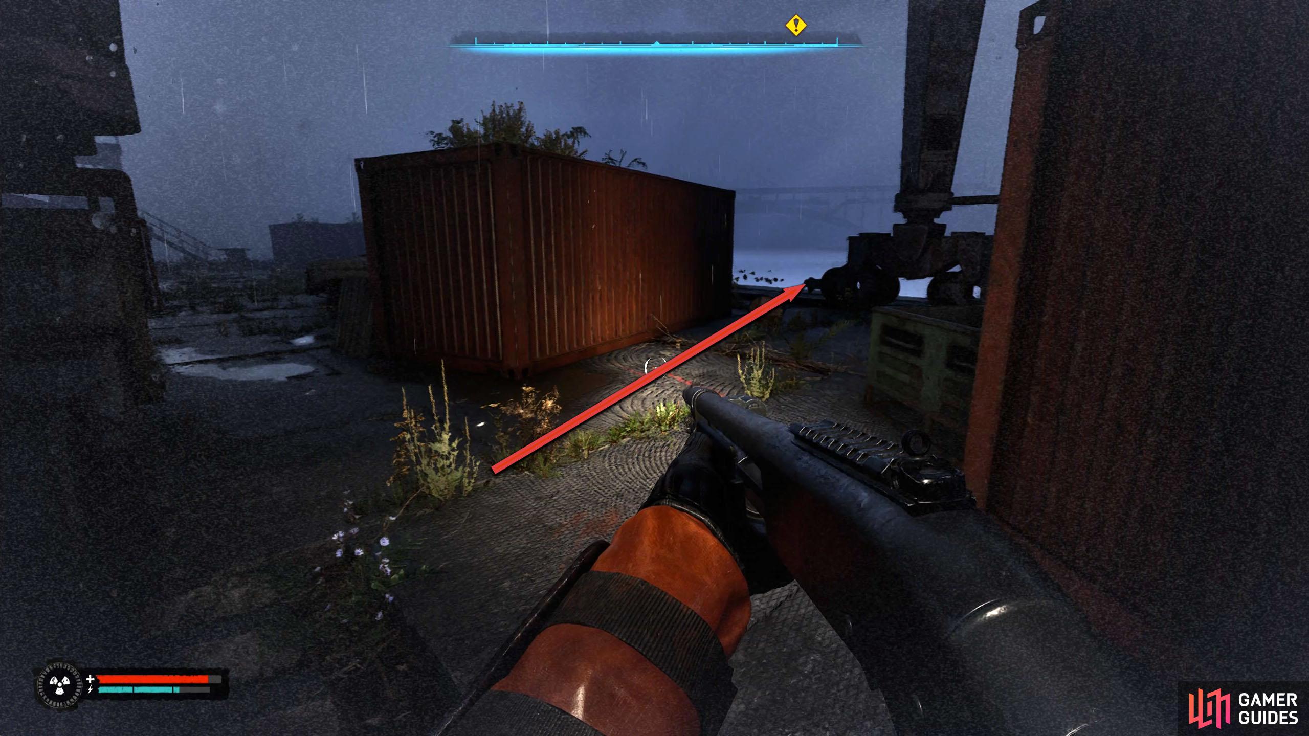 Head right at the red container under the crane, but hug the back of it to avoid the anomaly.