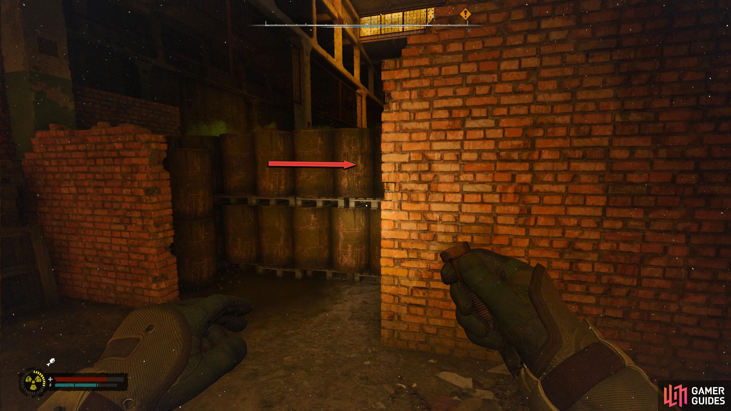 Head past the anomalies until you reach the pallets of metal drums.