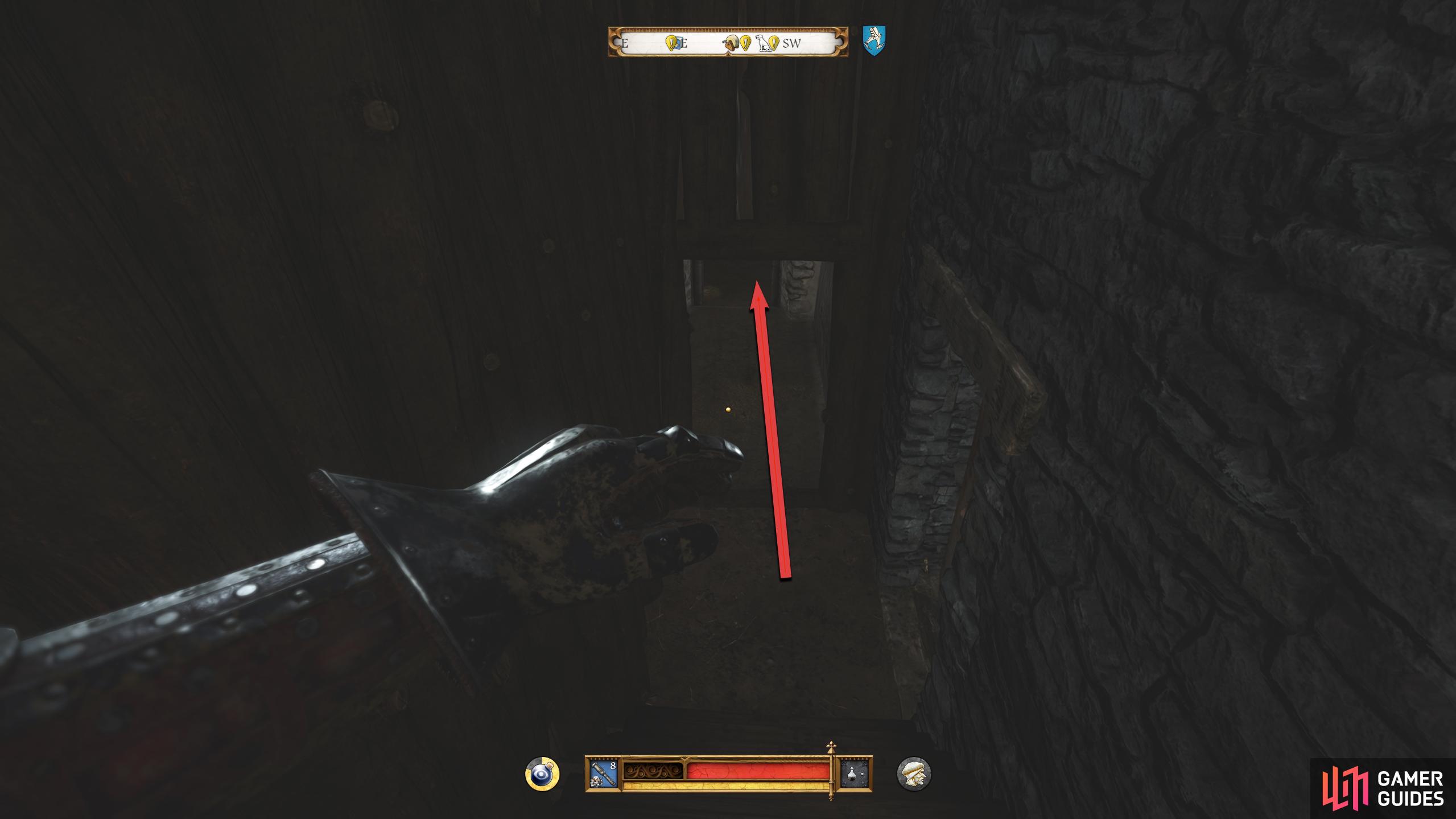 Go down the stairs to the left of the jail and head straight forward.