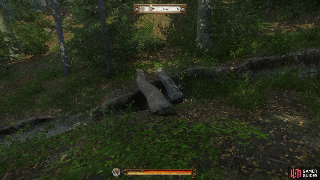 Cross the stream at the fallen tree and walk up the hill to the boulder. Continue on toward a smaller stream where the tiny mill can be found.