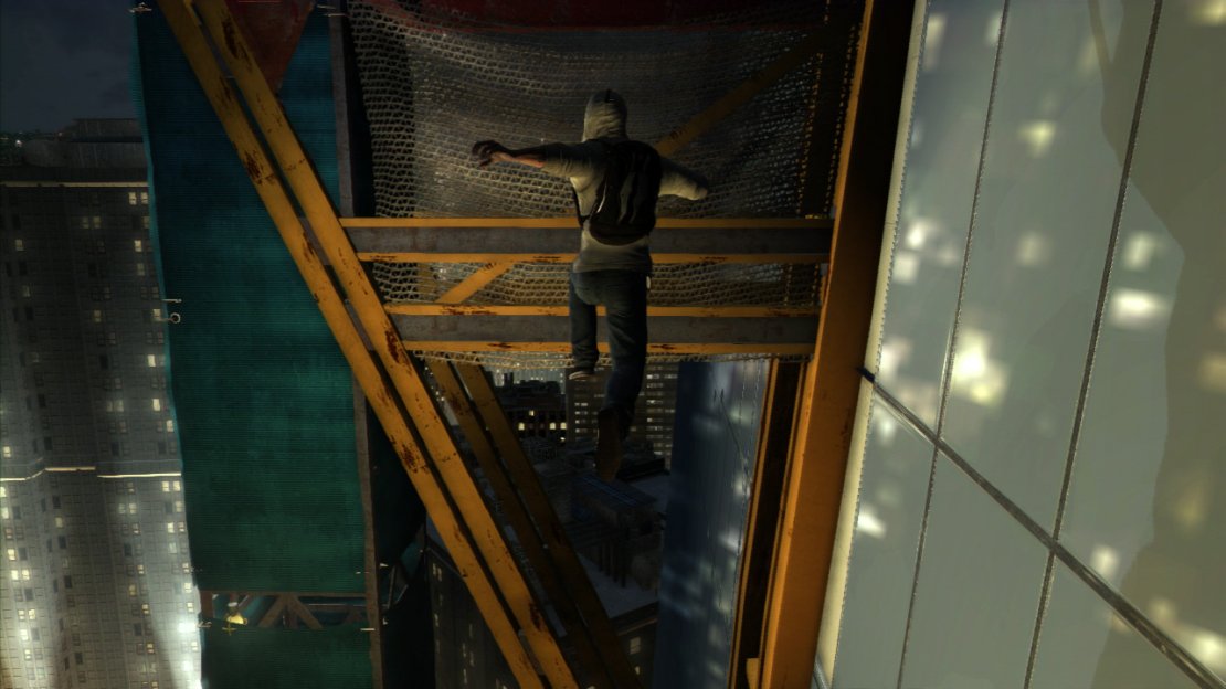 When you duck under the door to exit outside, climb the crane to the right. At the top, use the hanging girders to go around the corner (what the hell are they doing out at night? I’m sure there’s a safety issue there!) and use the wiring to climb up to the next level. Turn right, duck under the blockage here and work your way up the various boxes and girders until you reach the top of the building.