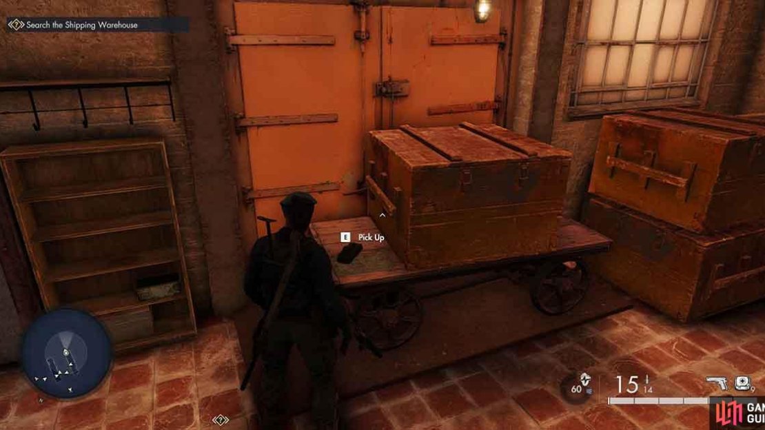The item is on top of these storage containers in a dark part of the warehouse.