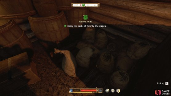 The sacks of flour are in the building to the right of the wagon.