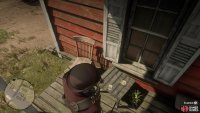 It’s on a table on the porch of the middle house