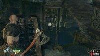 Throw the axe at the symbol when it’s revealed through the gap to lower the bridge.