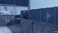 Simon is hiding in a container at the back left side of the roof