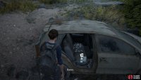 Once you reach the road with Joel, head left to find this Trading Card sitting inside the car in the water 