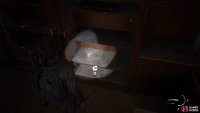 Go to the back of the room and smash the glass behind the counter to find a Trading Card