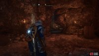 Slide under the crack in the wall to access the hidden room.