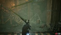 Follow the stairs to the top of the room.