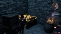 The chest can be found inside, behind some crates.