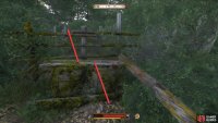 Go behind the ruins and use the barrels to jump over the fence.